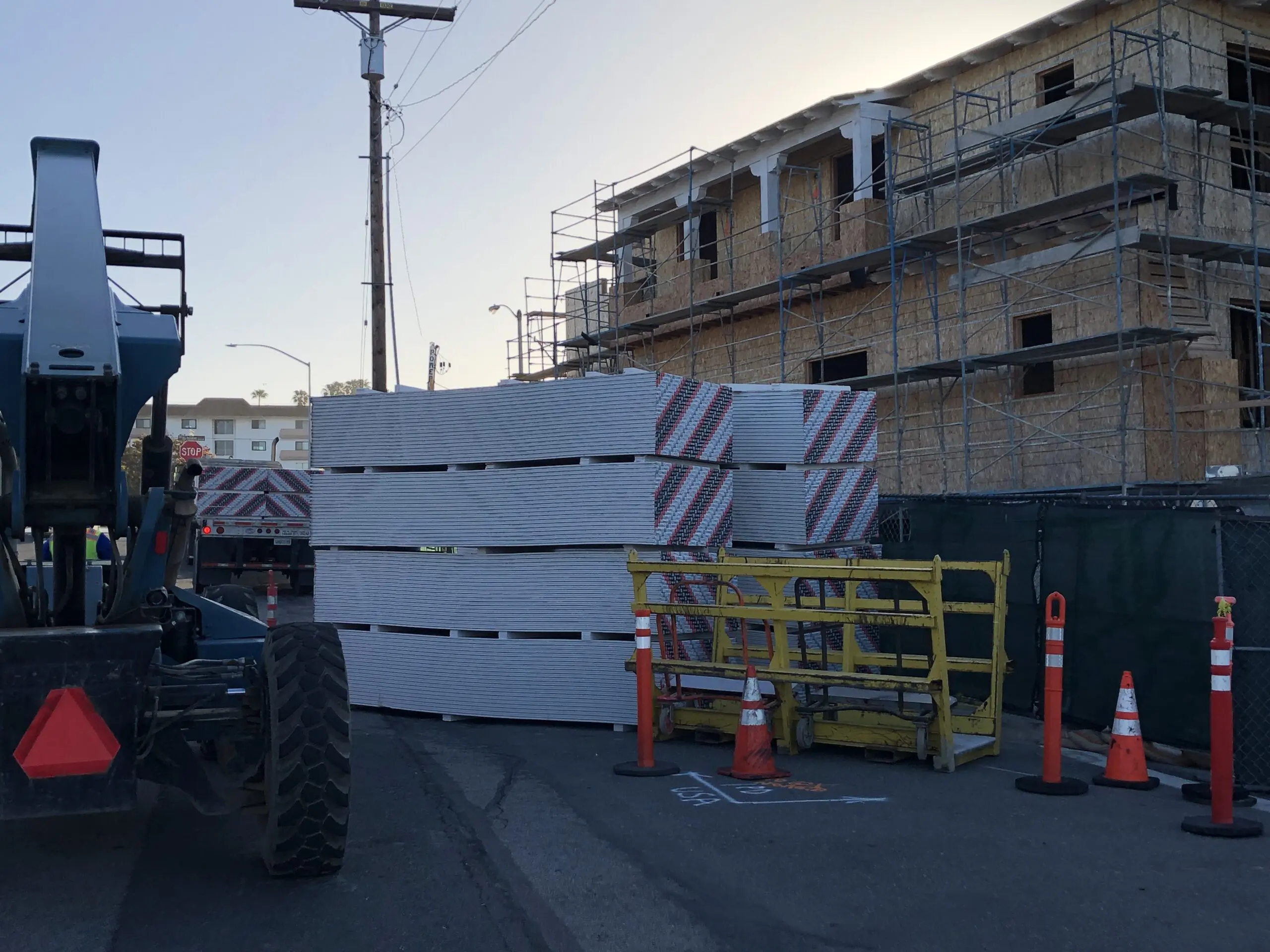 Construction site with a large pile of white and red blocks on the side of the road