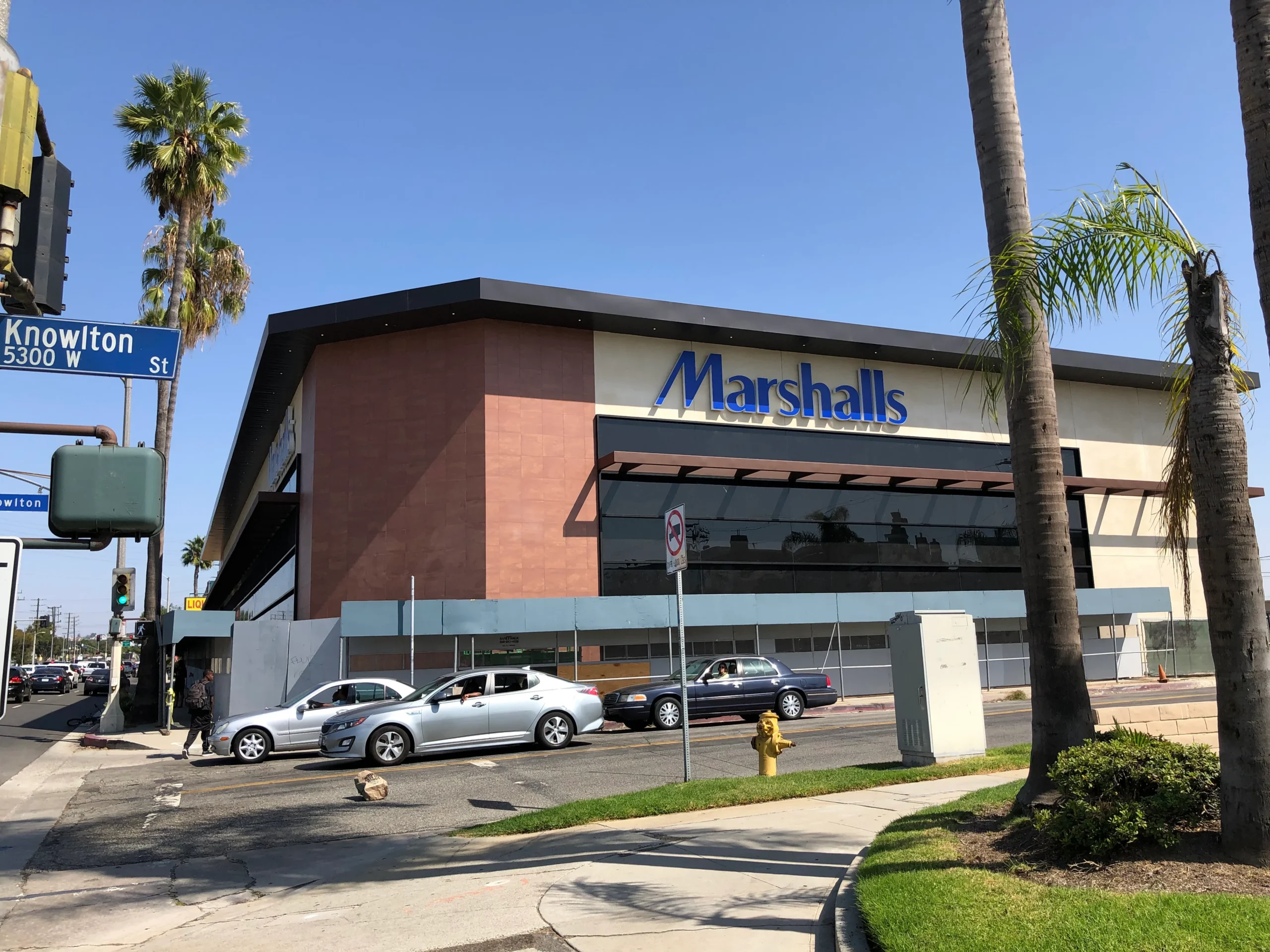 Marshall's store on the corner of a street with cars parked in front of it